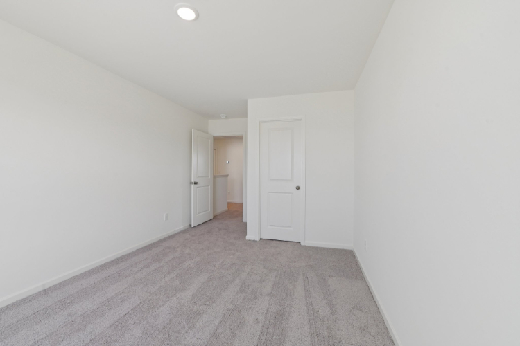 A hallway with white doors.