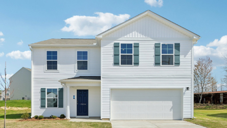 A white house with a garage.