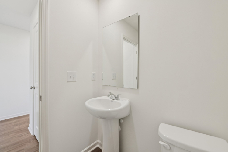 A bathroom with a sink and mirror.