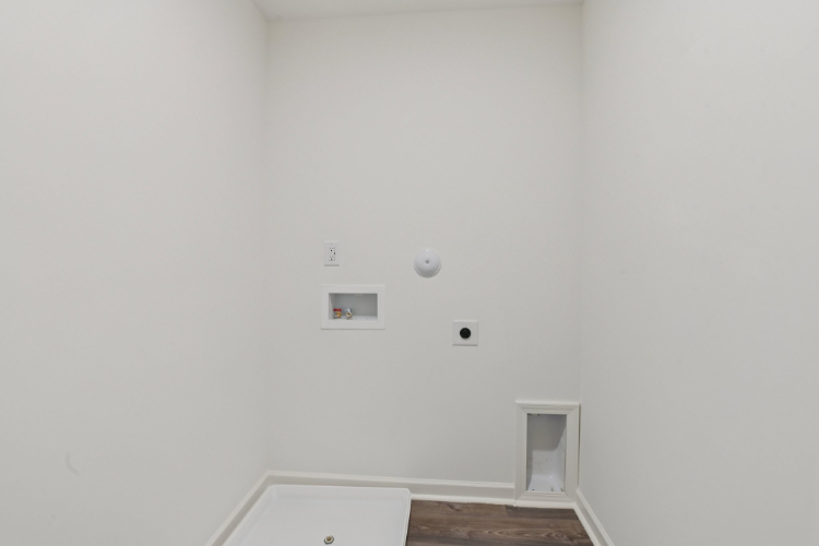 A white wall with a light on it.