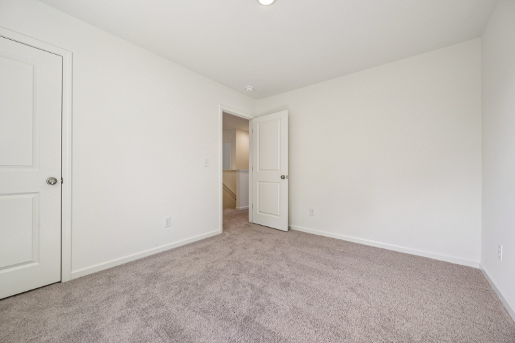 A hallway with white doors.