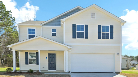 A white house with a garage.