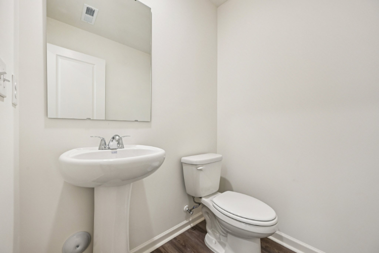 A bathroom with a toilet and sink.