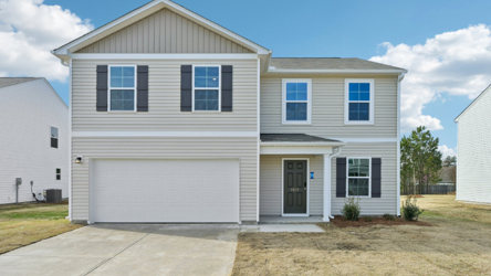 A white house with a garage.