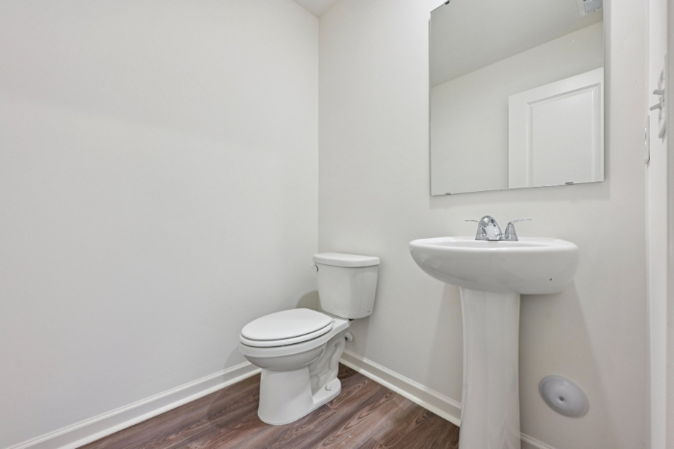 A bathroom with a toilet and sink.