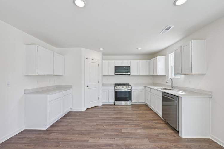 A kitchen with white cabinets.