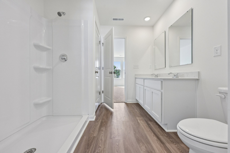 A bathroom with a tub and toilet.