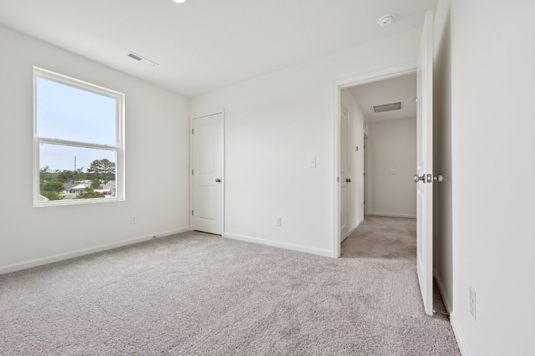 A room with white walls and a window.