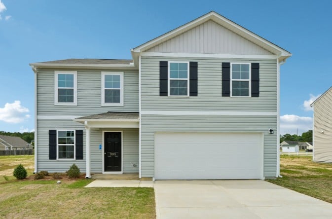 A white house with a garage.