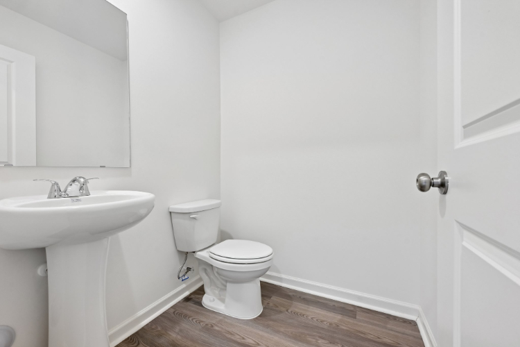 A bathroom with a toilet and sink.