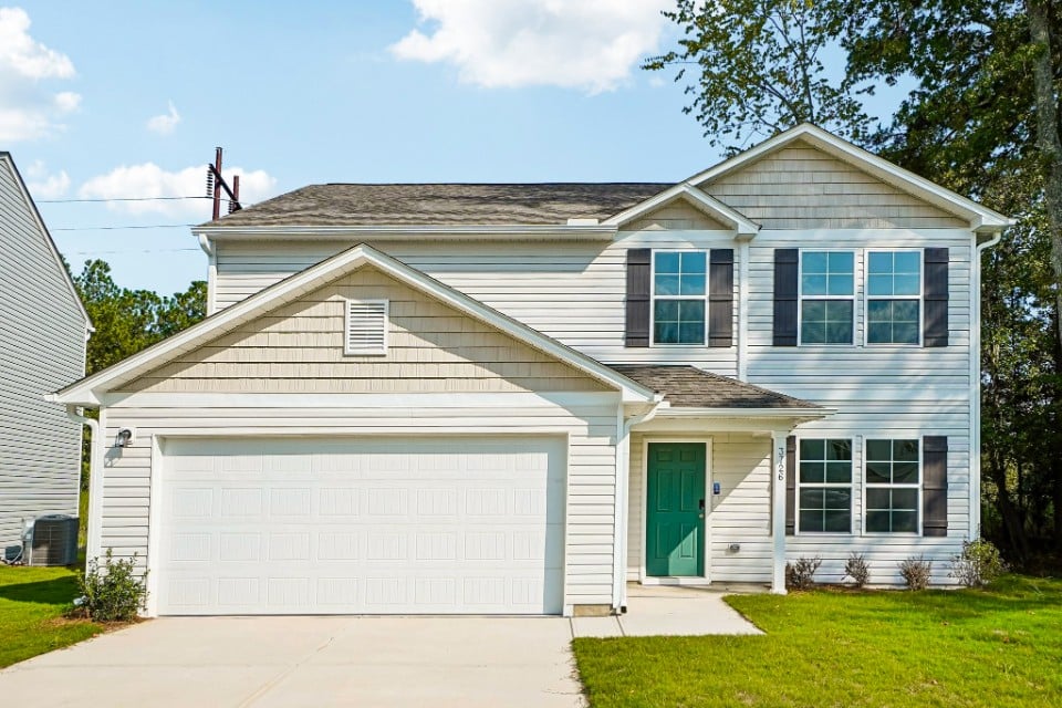 A white house with a garage.