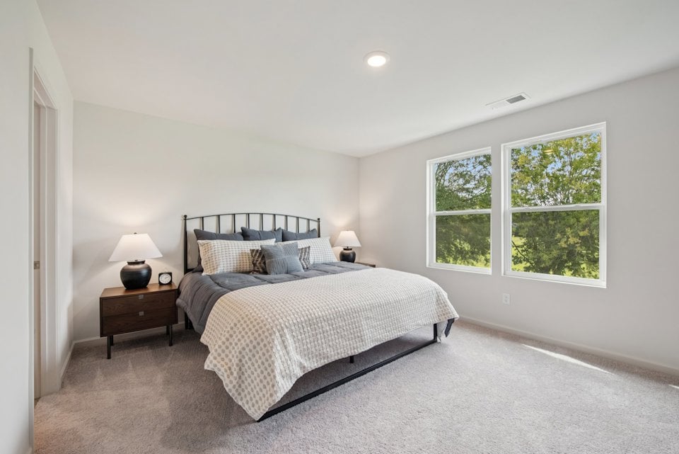 A bedroom with a bed and a window.