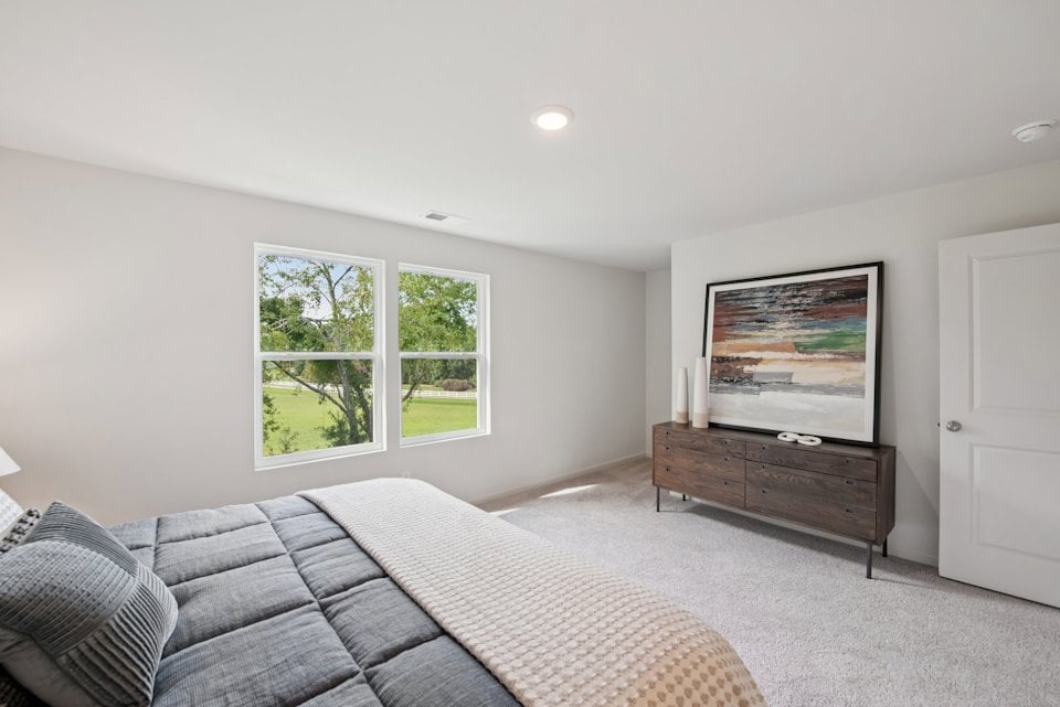 A room with a bed and a window.