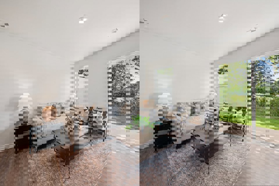 A living room with a large glass door.