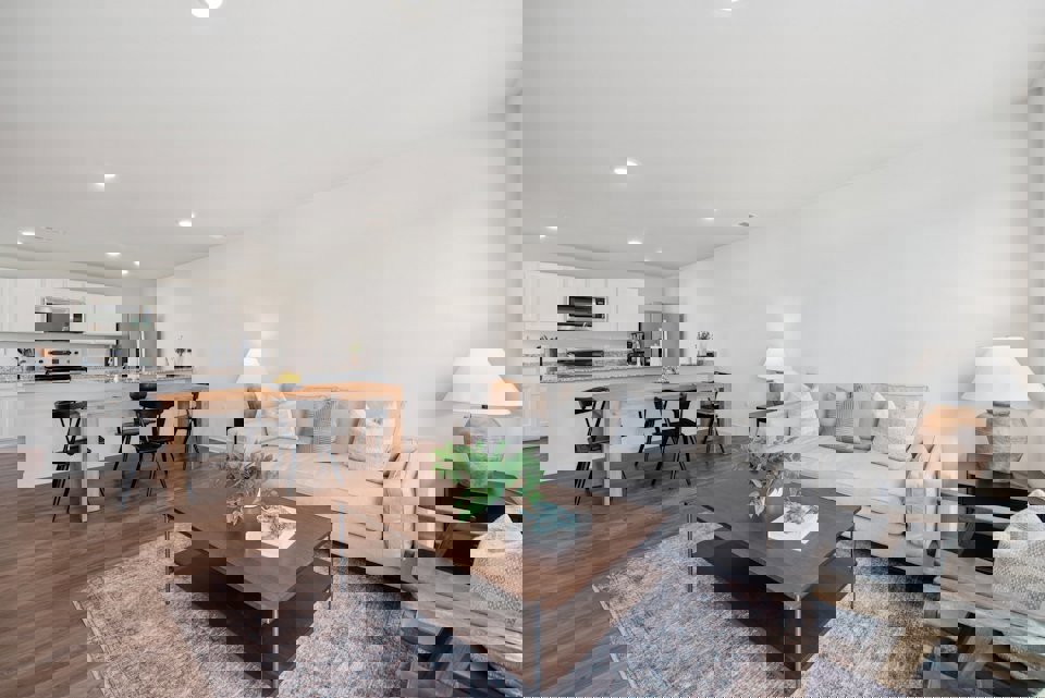 A living room with a couch and a table.