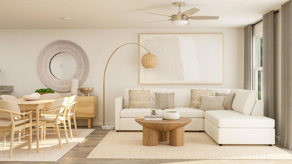 A living room with a white couch and a table.