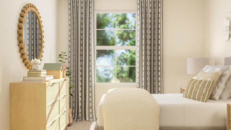 A room with a white couch and a white chair.