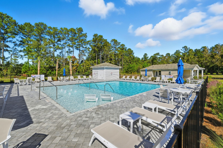 A swimming pool with chairs around it.