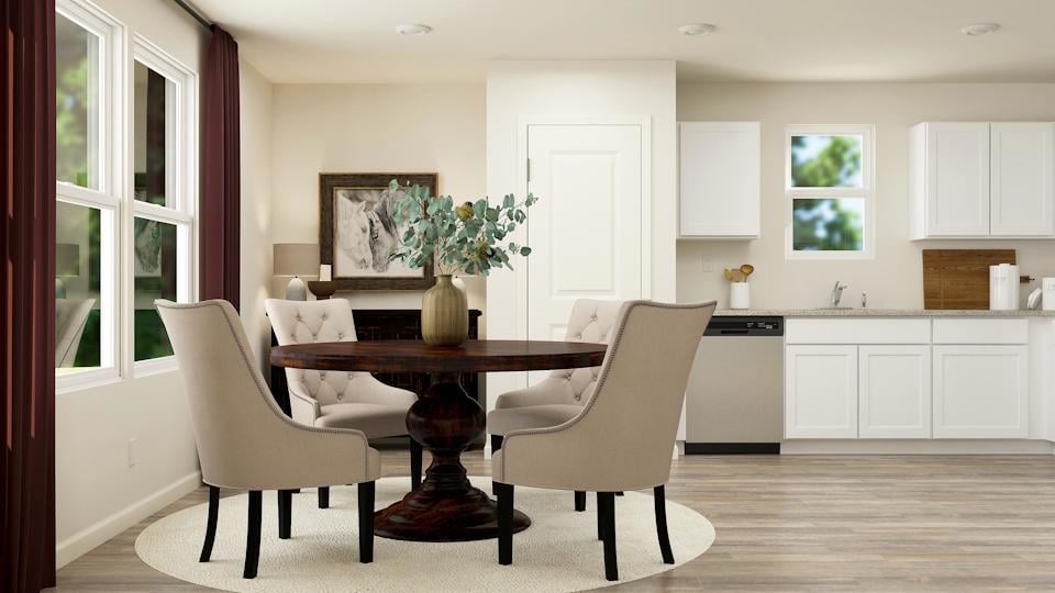 A dining room with a table and chairs.