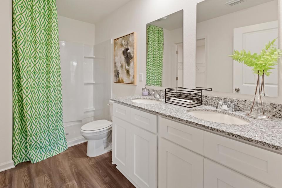 A bathroom with a large mirror.