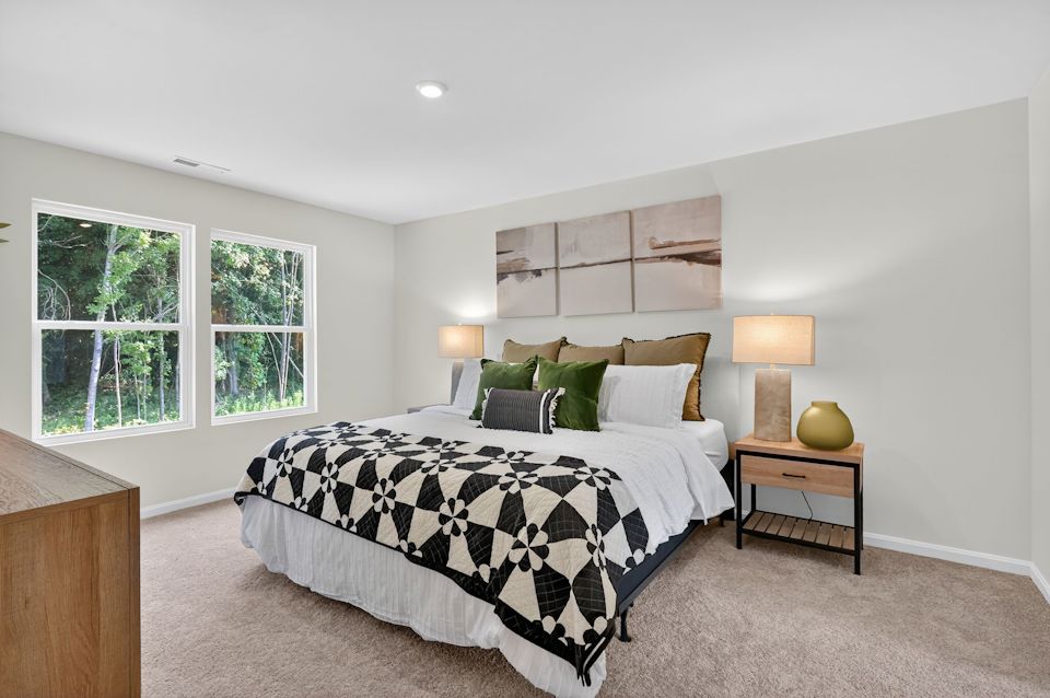 A bedroom with a bed and a desk.