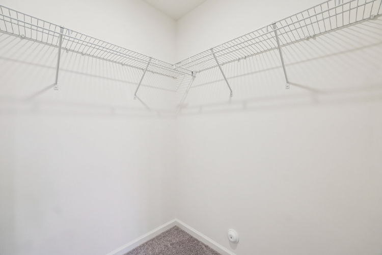 A white wall with a metal railing.