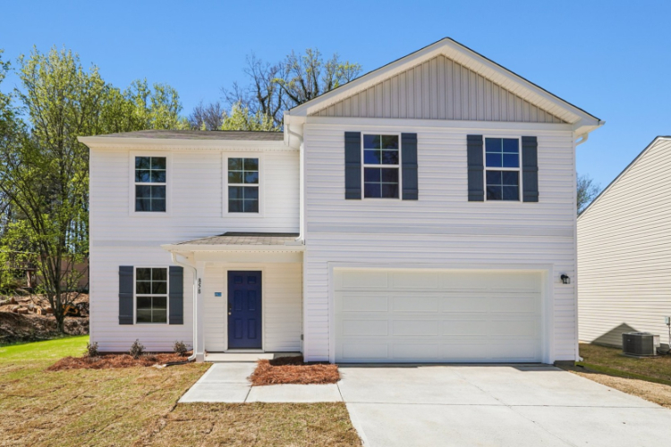 A white house with a garage.