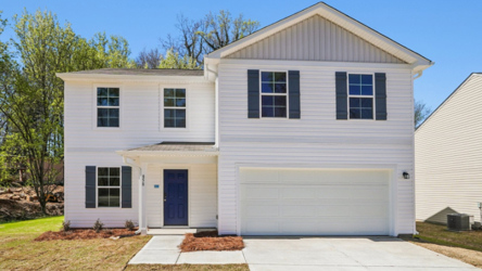 A white house with a garage.
