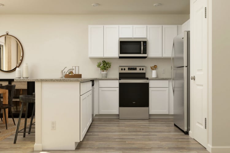 A kitchen with white cabinets.