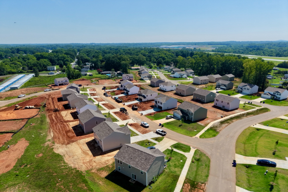A group of houses in a field.