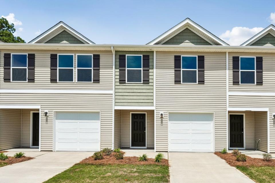 A house with garages and a driveway.