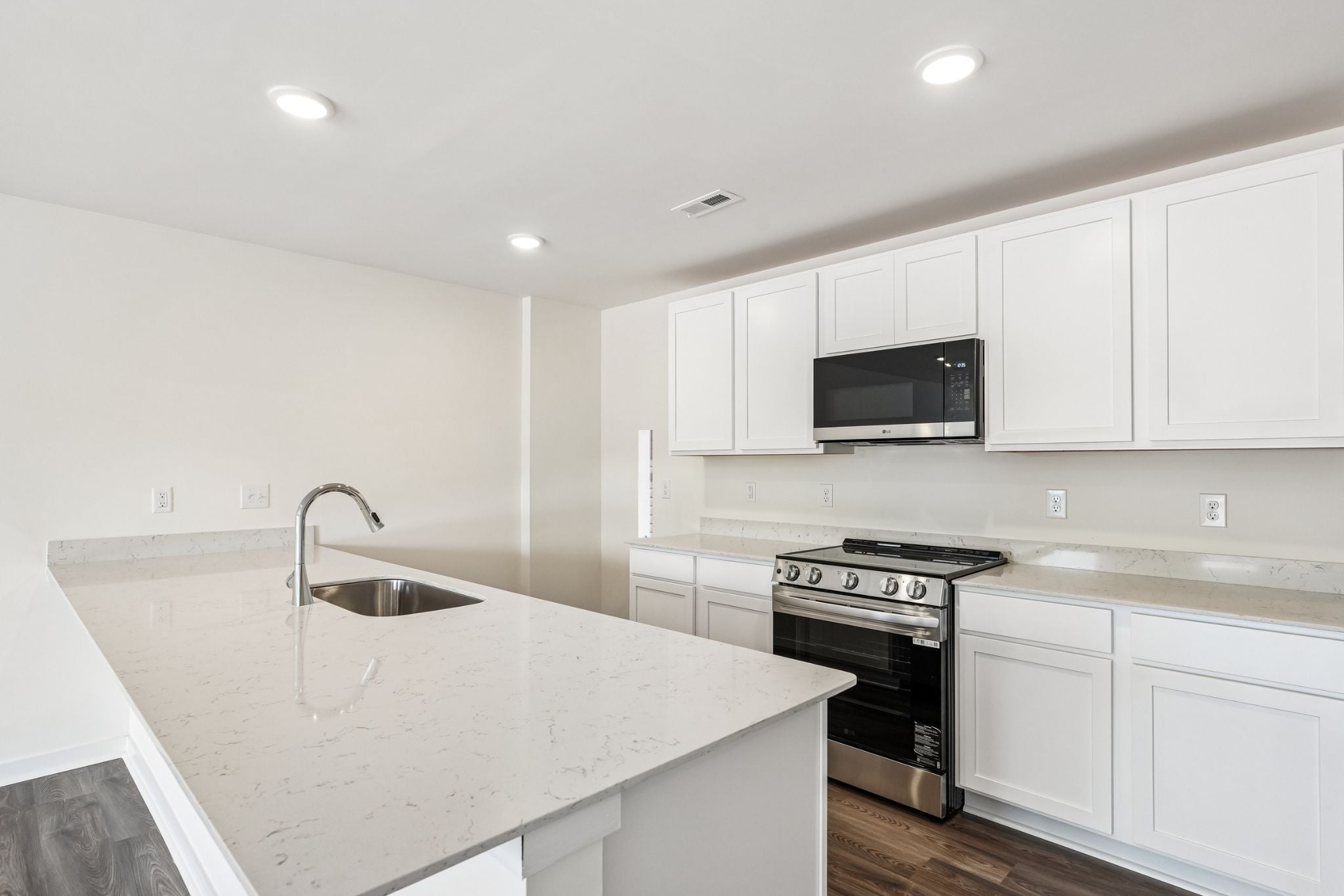 A kitchen with white cabinets.