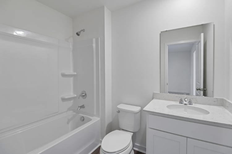 A bathroom with a toilet sink and bathtub.