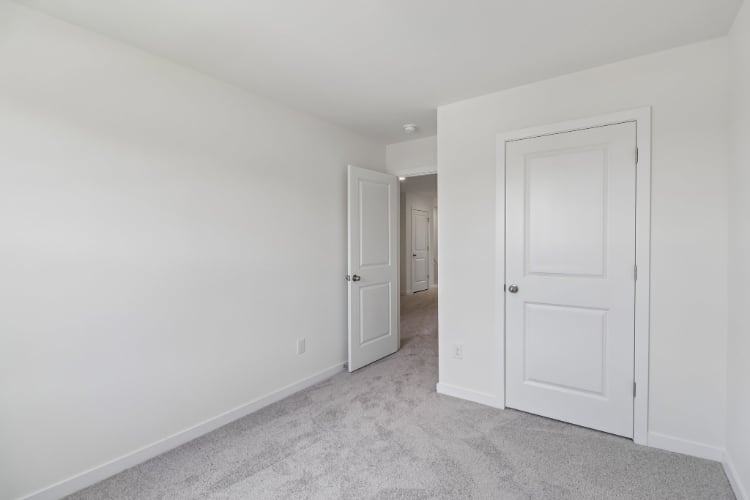 A hallway with white doors.