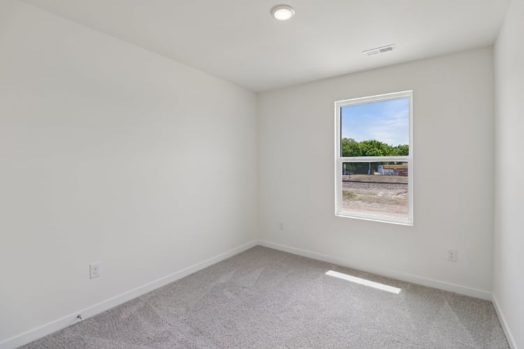 A white room with a painting on the wall.
