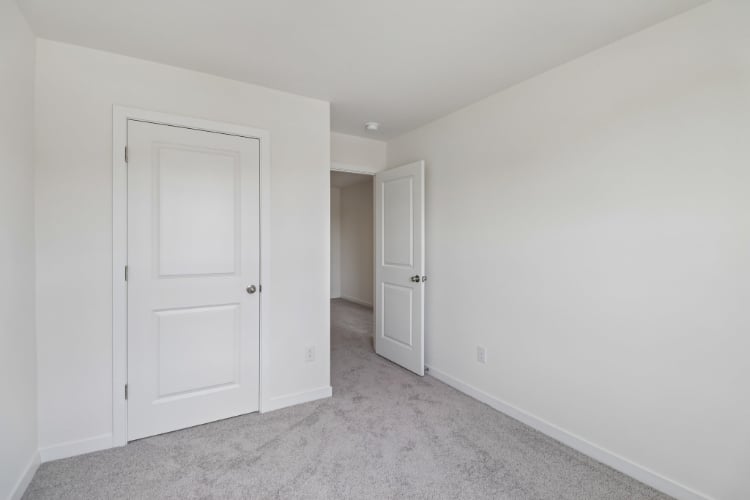 A hallway with white doors.