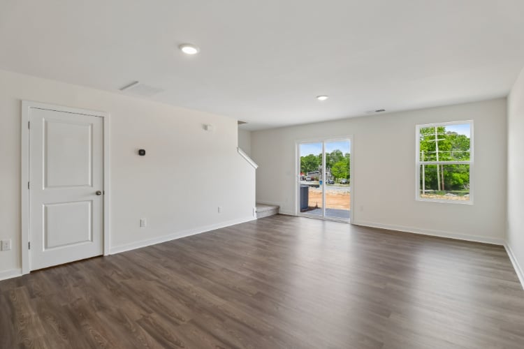 A room with a wood floor and white walls.