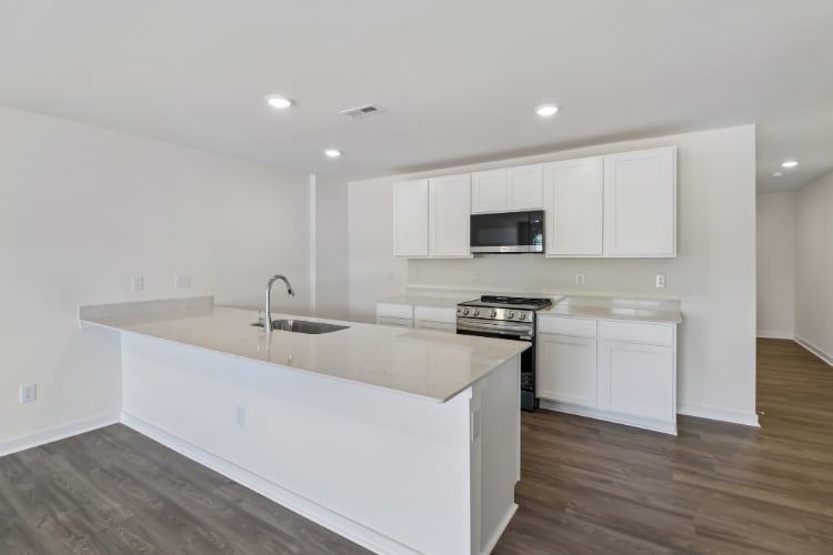 A kitchen with white cabinets.