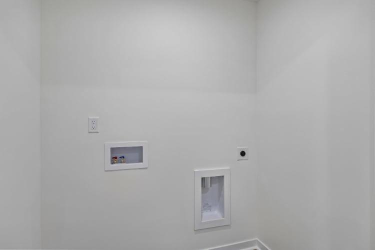 A white wall with a couple of switches on it.