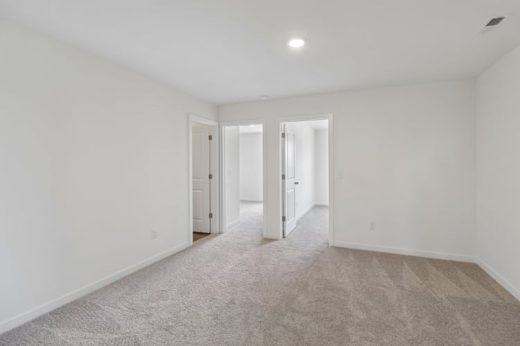 A hallway with white doors.