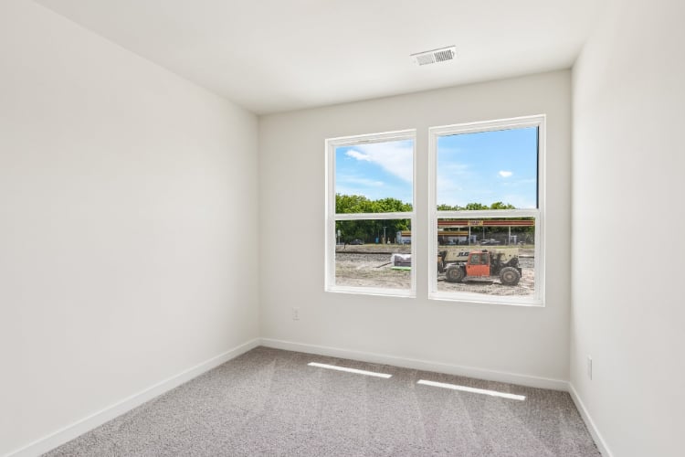 A room with a window and a car outside.