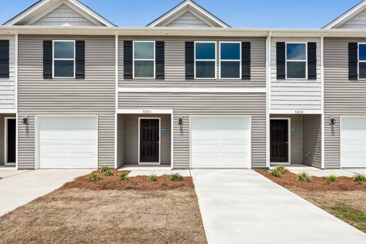 A house with garages and a driveway.