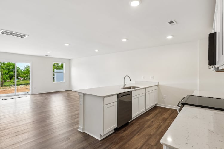 A kitchen with white cabinets.