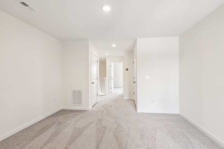 A long hallway with white walls.