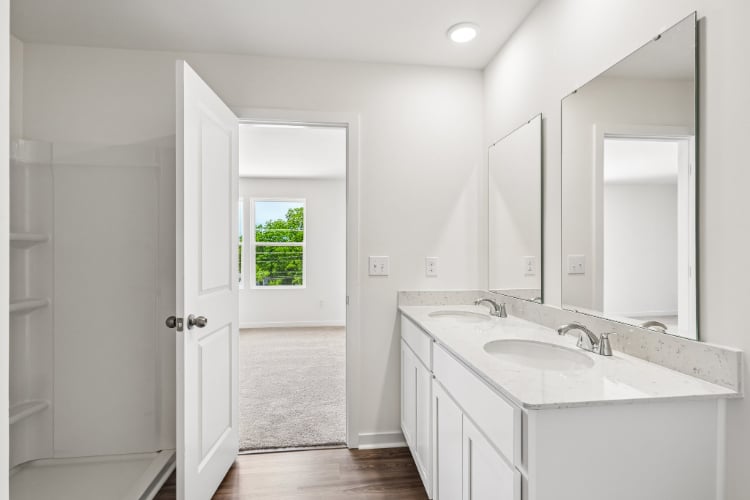 A bathroom with white cabinets.