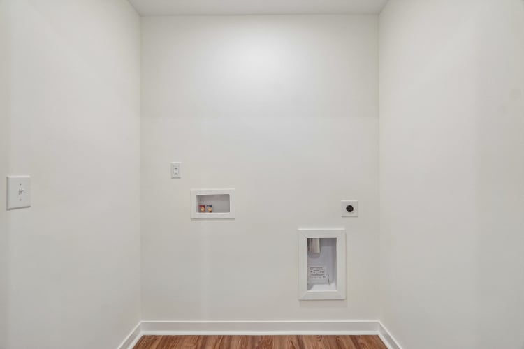 A white wall with a light switch.