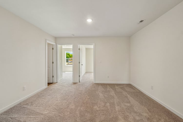A hallway with white doors.