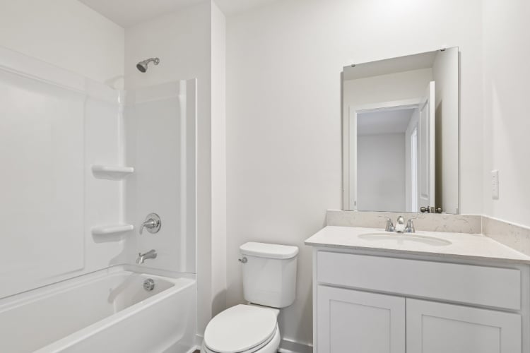 A bathroom with a toilet sink and bathtub.