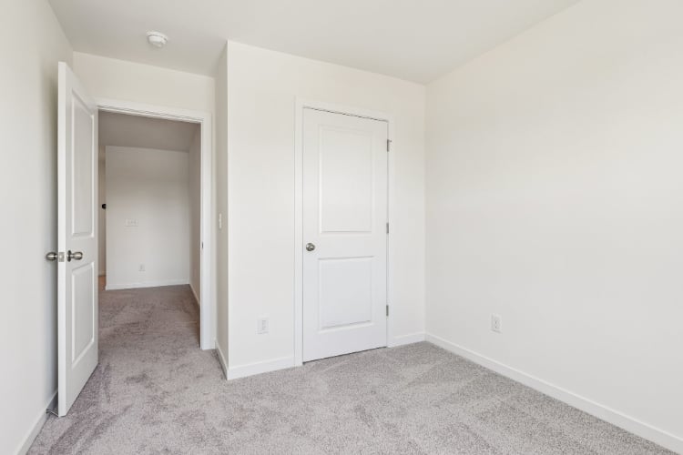 A hallway with white doors.