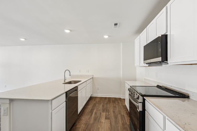 A kitchen with white cabinets.